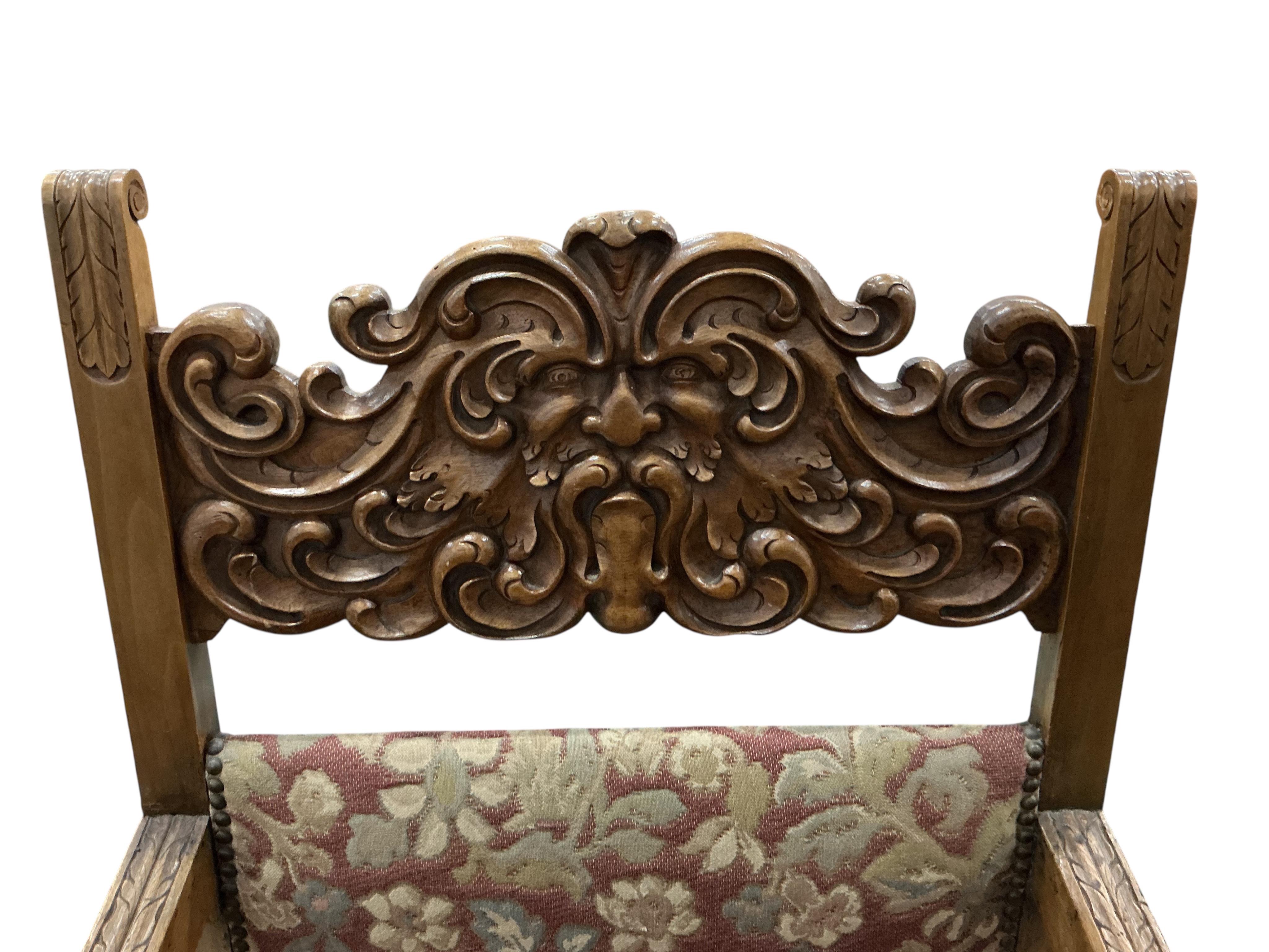 An 18th century style carved walnut elbow chair, width 56cm, depth 54cm, height 111cm